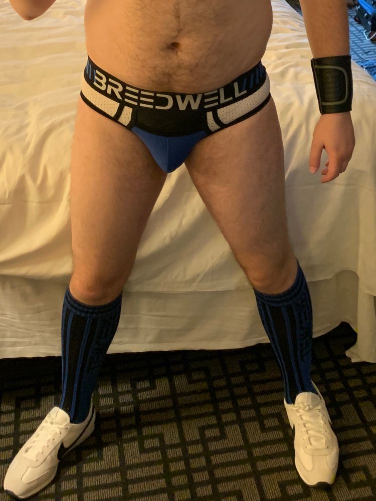 Photo of me from the belly-down wearing Breedwell “easy-access” blue and white mesh briefs, knee-length blue socks, and white sneakers 