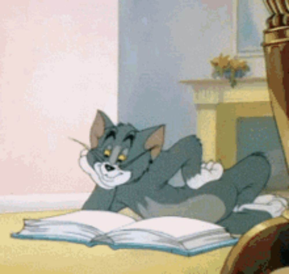 tom from tom and jerry is laying on the floor reading a book