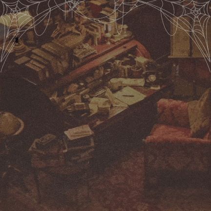 Aziraphale's desk filled with books and notes and stuff. Spiderwebs. Moving dust clouds. 