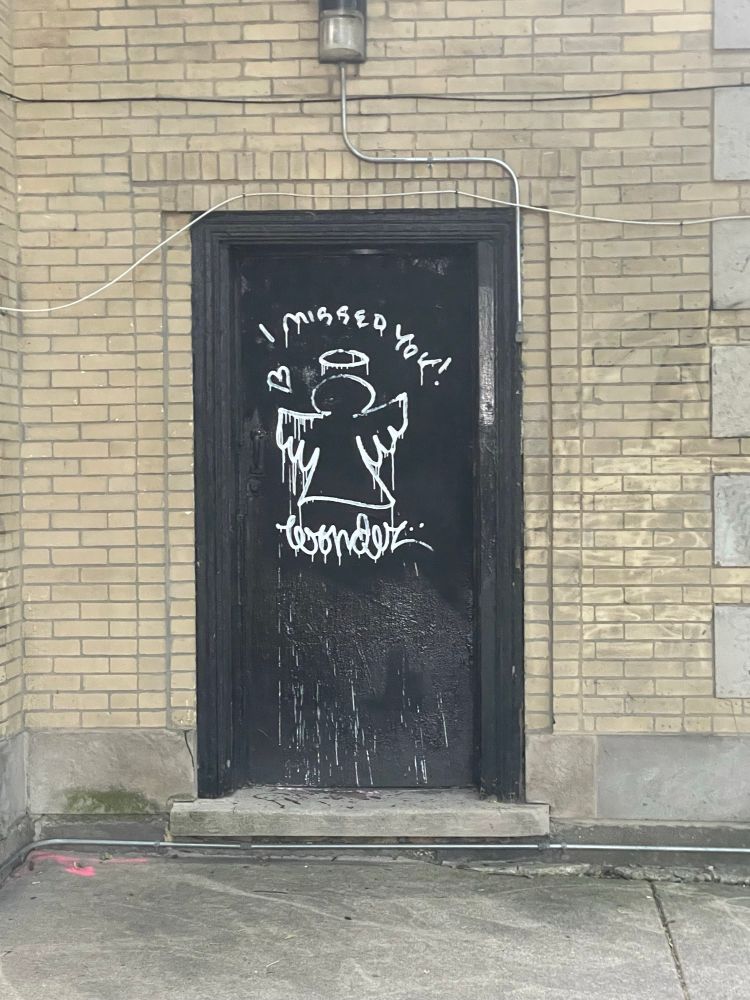 graffiti painting of an angel that says "i missed you!" signed by wonder