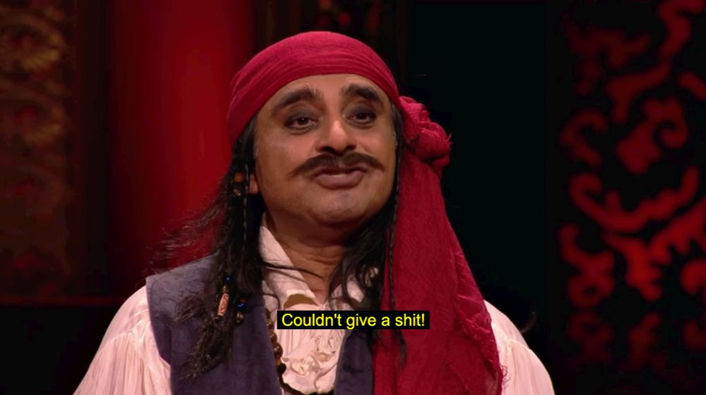 Sanjeev Bhaskar, dressed as a pirate, saying, "Couldn't give a shit!"