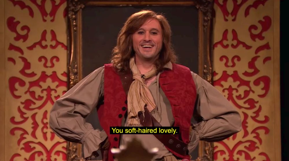 Phil Ellis, dressed like a pirate, with his hands on his hips and looking very pleased. Off screen, Greg Davies addresses him as, "You soft-haired lovely."