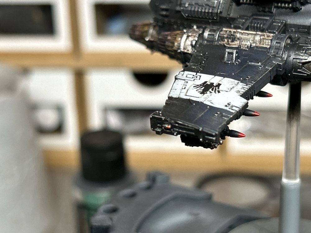 Closeup of the right wing of a Legions Imperialis Space Marine Thunderhawk painted in Raven Guard colors.