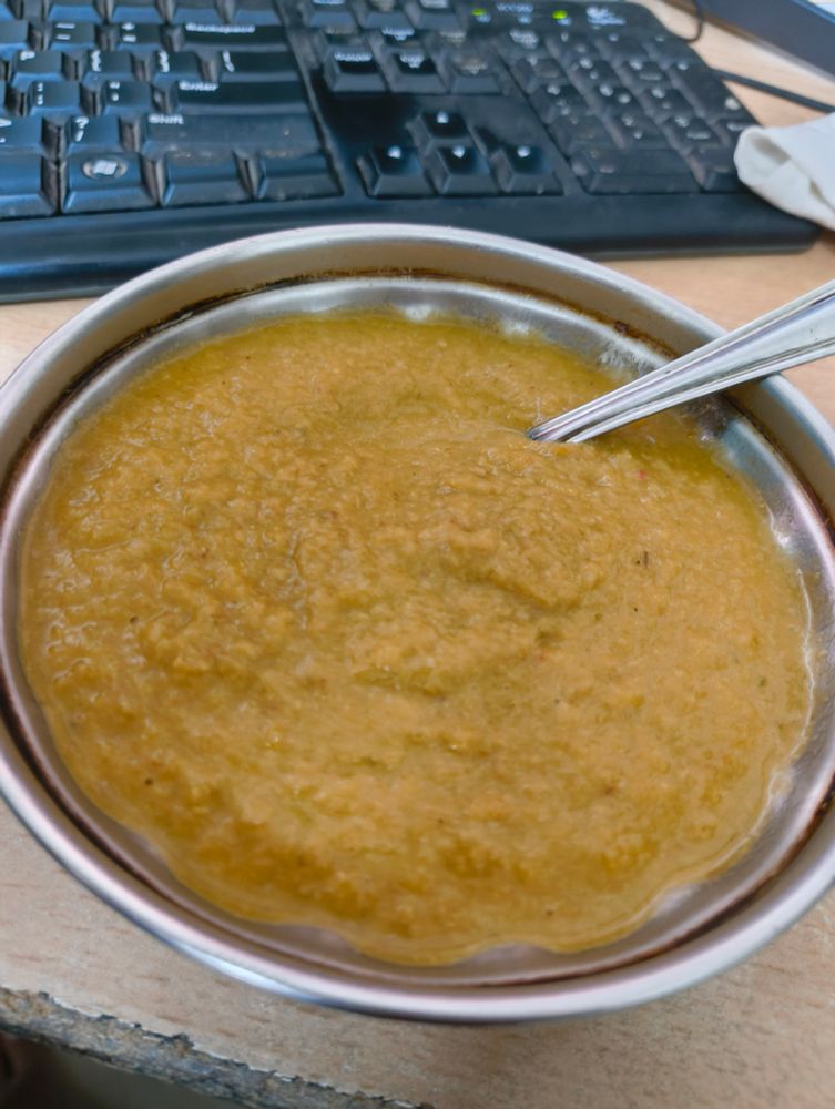 yellow colored soup in a bowl