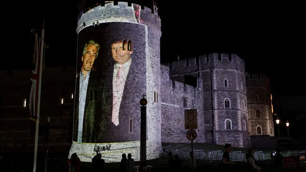 The image of the two sex offenders projected on one of the curved walls of the castle. From Reuters.
