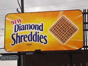 A roadside billboard showing a Shreddie cereal piece as a diamond instead of a square 