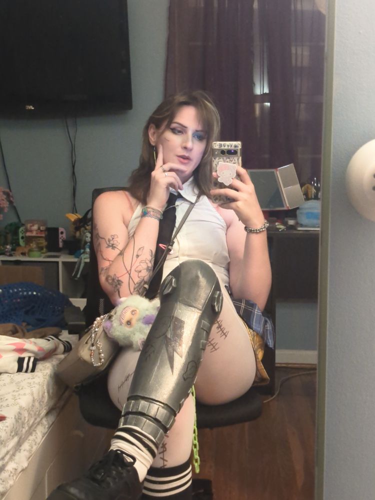 Layne partially in her Frankie costume, seated at the end of a long day at the convention. 