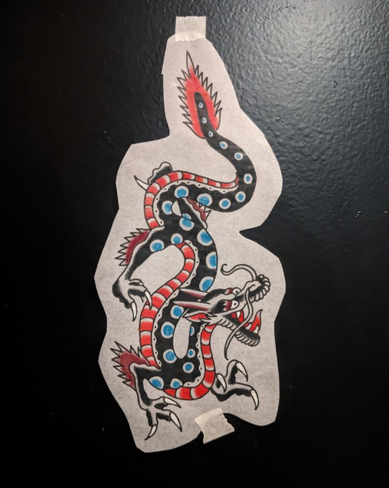 A dragon drawing done in a traditional tattoo style. it features bold lines, heavy black shading, and a minimal color palette of red, brown, and green