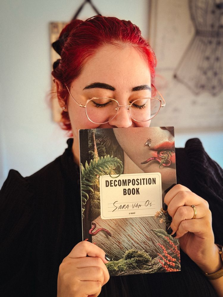 Sara holding her ARC of Decomposition Book