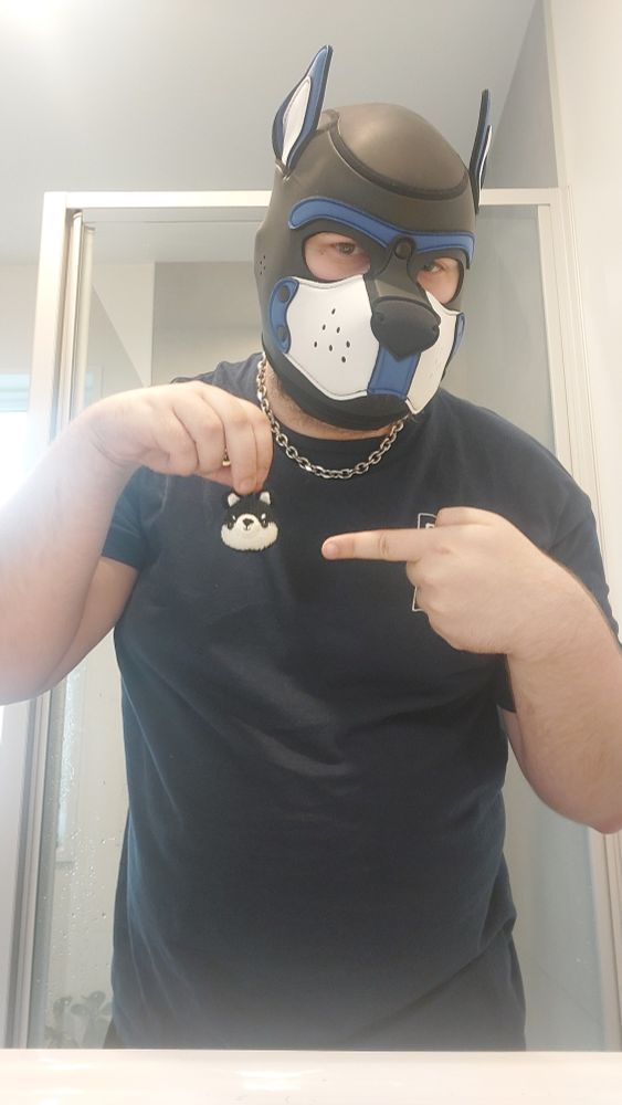 Brewski pointing at a small dog head keychain