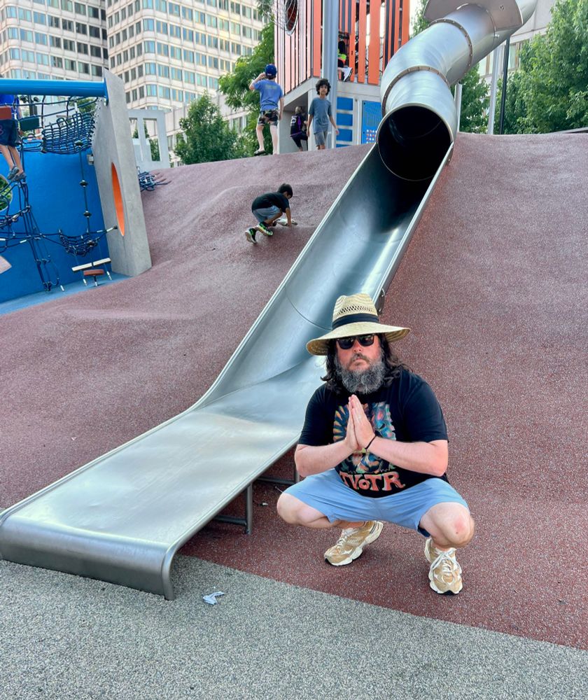 a bearded man in a big dumb hat does a rap squat in respectful tribute to the legendary Boston cop slide 