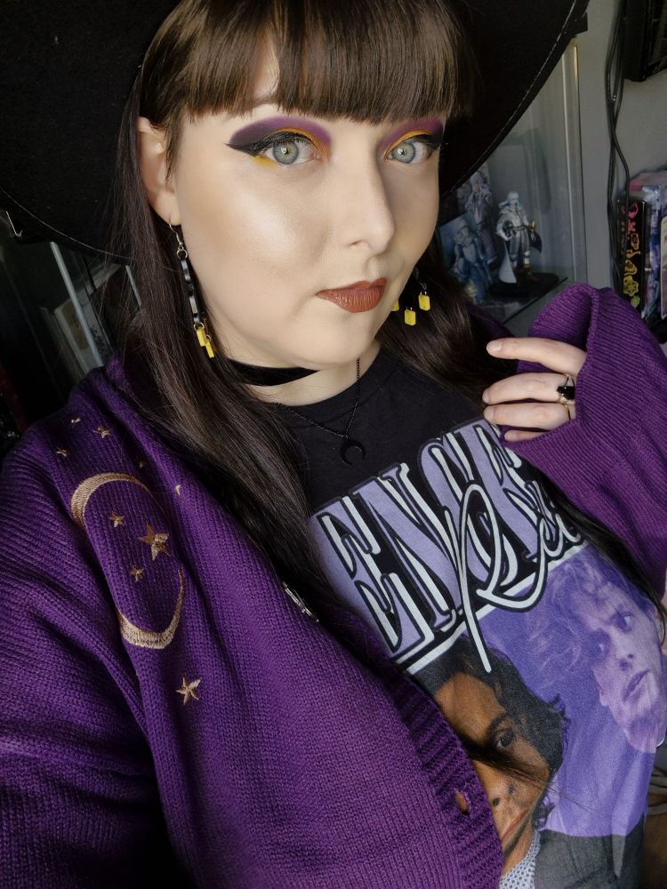 Photo of myself wearing a purple cardigan and a Criminal Minds shirt.