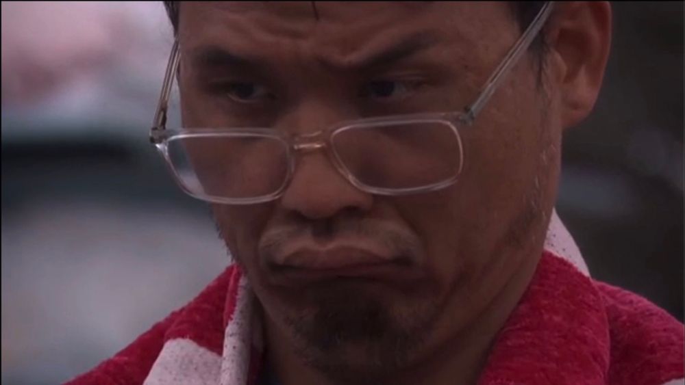 Kimo bb26 looking over his glasses with lips pursed.