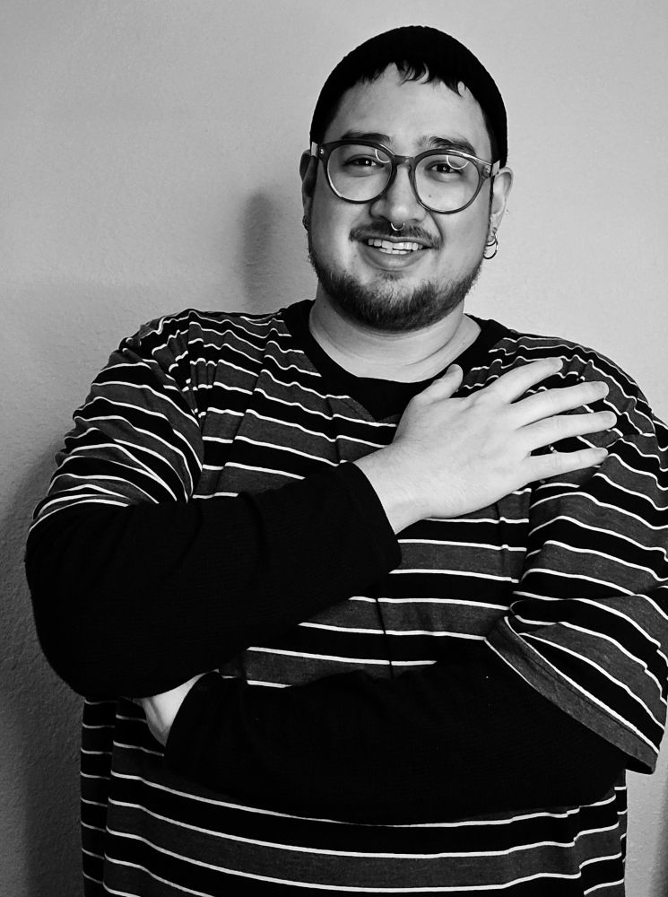 B&W myself wearing a stripe shirt, one arm across my chest 