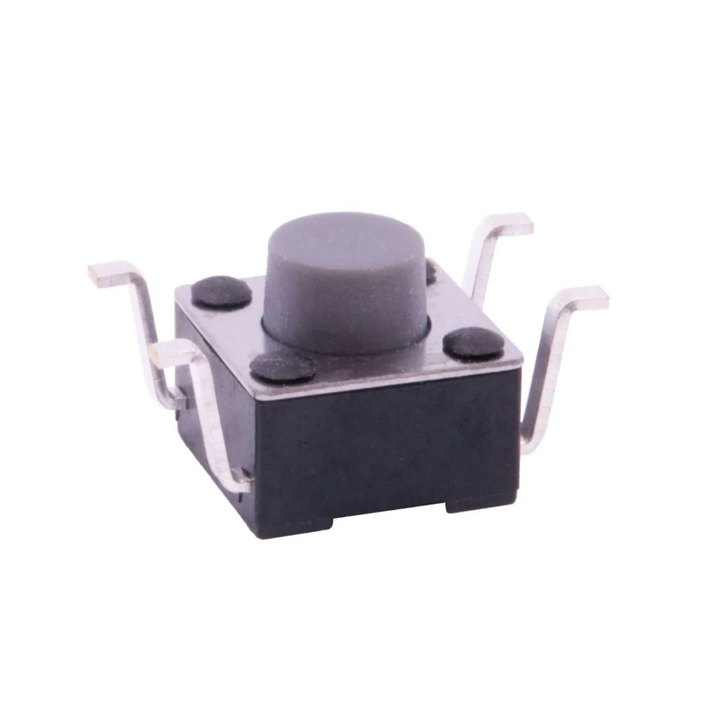 A photo of a reverse mount SMD button with the four leads pointing up, looking like shrugging arms.