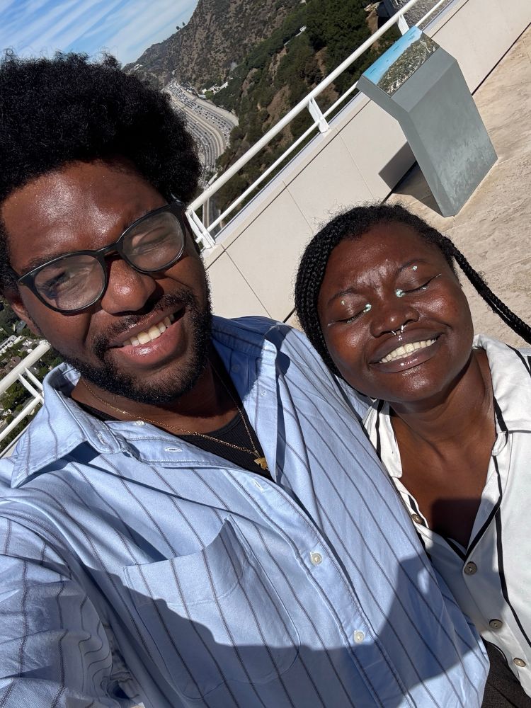 Asaaseyaa’s avatar and (one of)  their partner(s) smiling hard, with sun in their eyes 