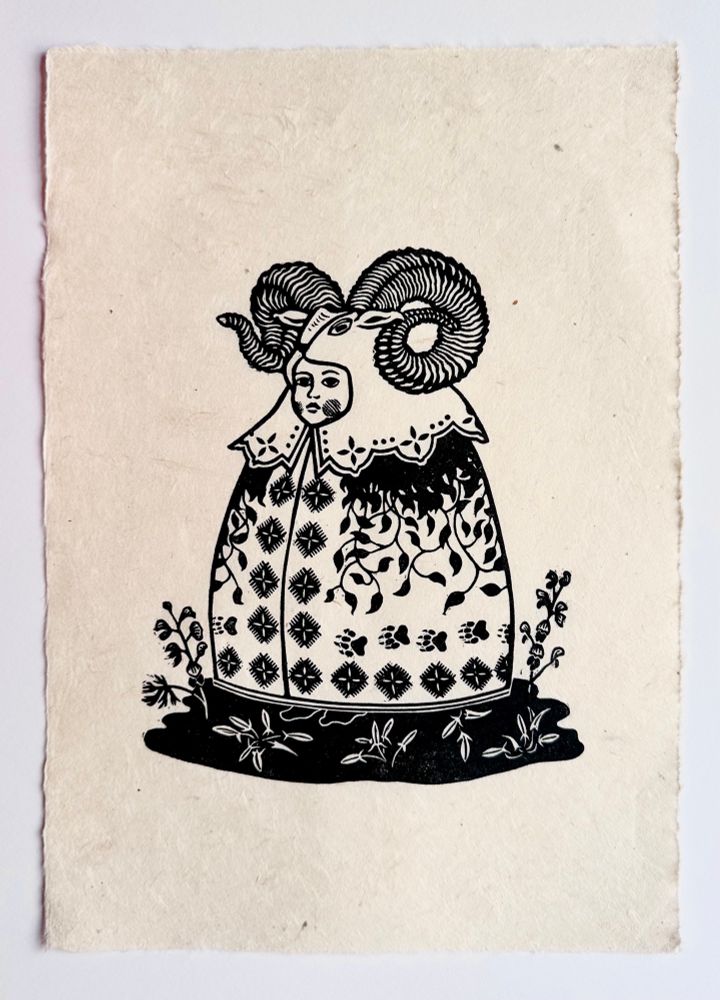 A strange costumed child with rams head hood