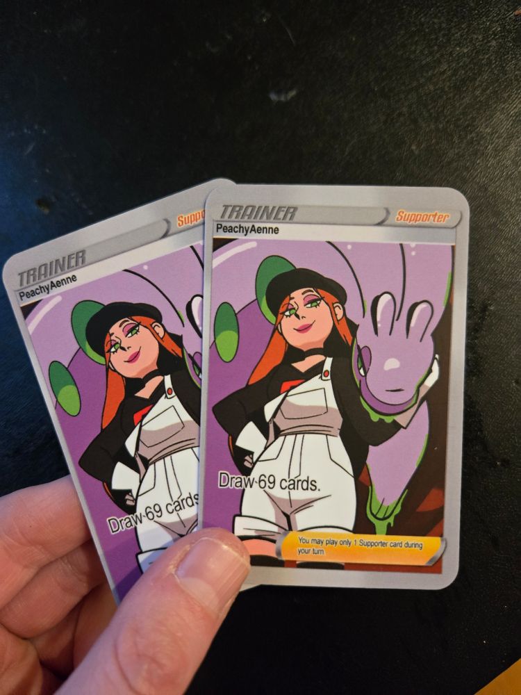 I'm holding 2 of my team rocket business cards - which is me as a team rocket grunt and my goodra