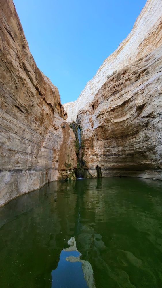 Lake in a small canyon with a narrow waterfall