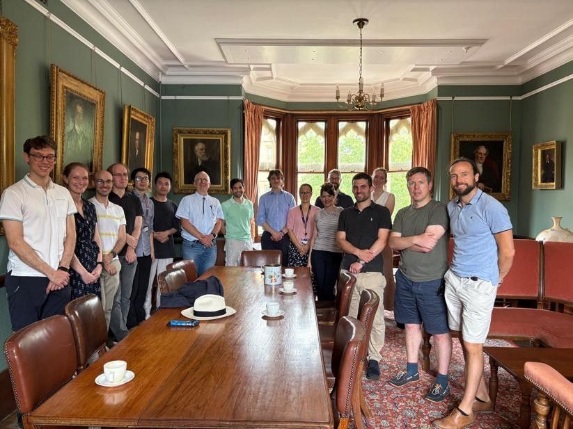 A group of people pose for the camera in the HMC Senior Common Room