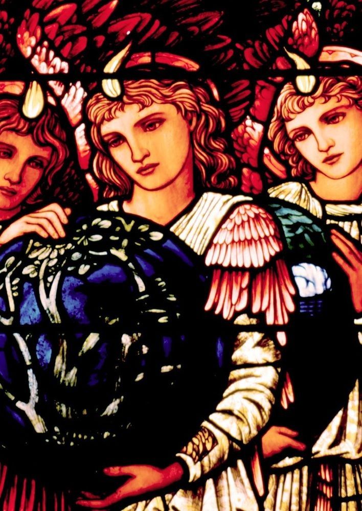 Detail of a stained glass window. A group of angels gather behind a globe.