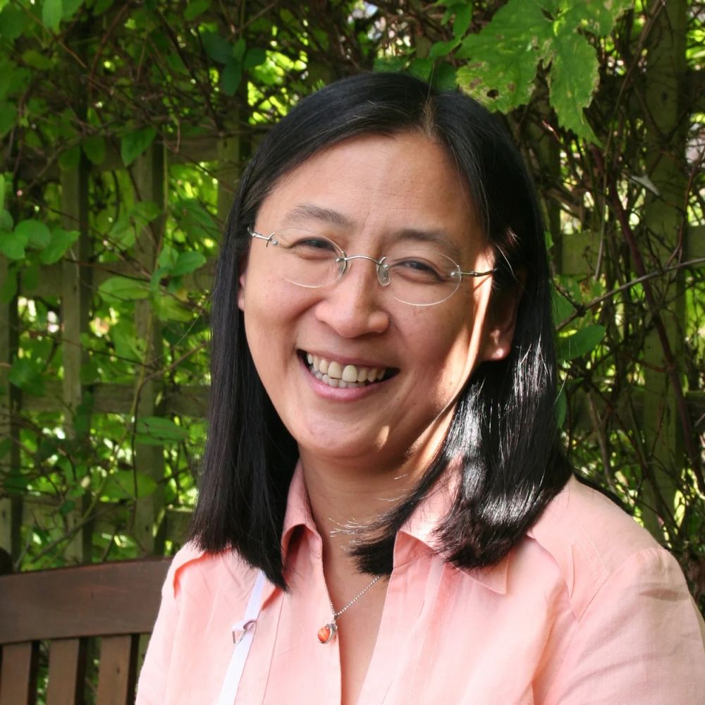 Woman wearing glasses and pink shirt (Prof Bee Wee)