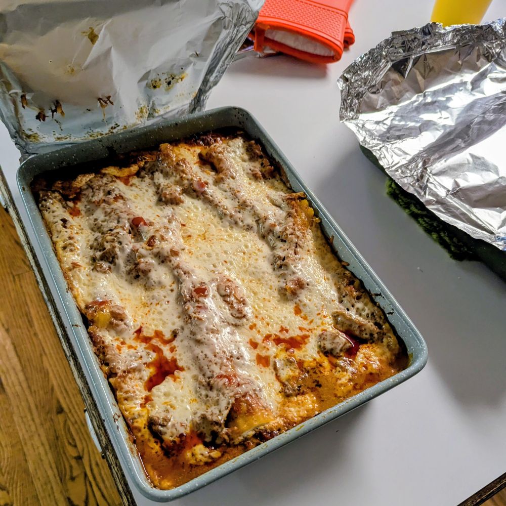 hot lasagna in a pan on a trivet atop a counter