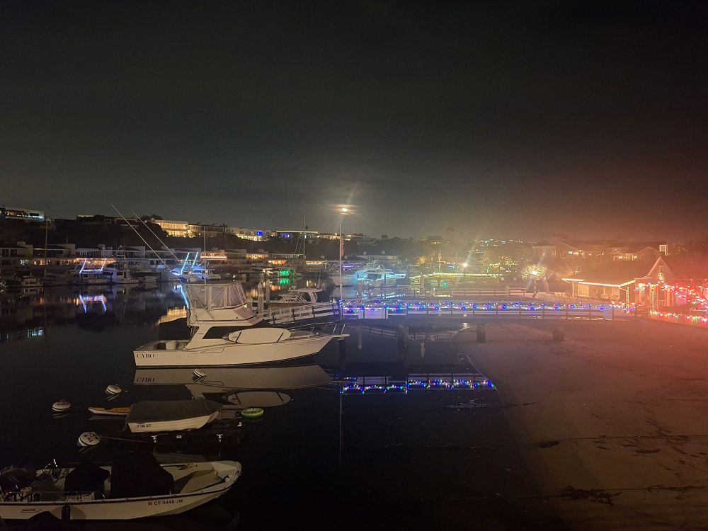 Harbour boats and Christmas lights in the moonlight