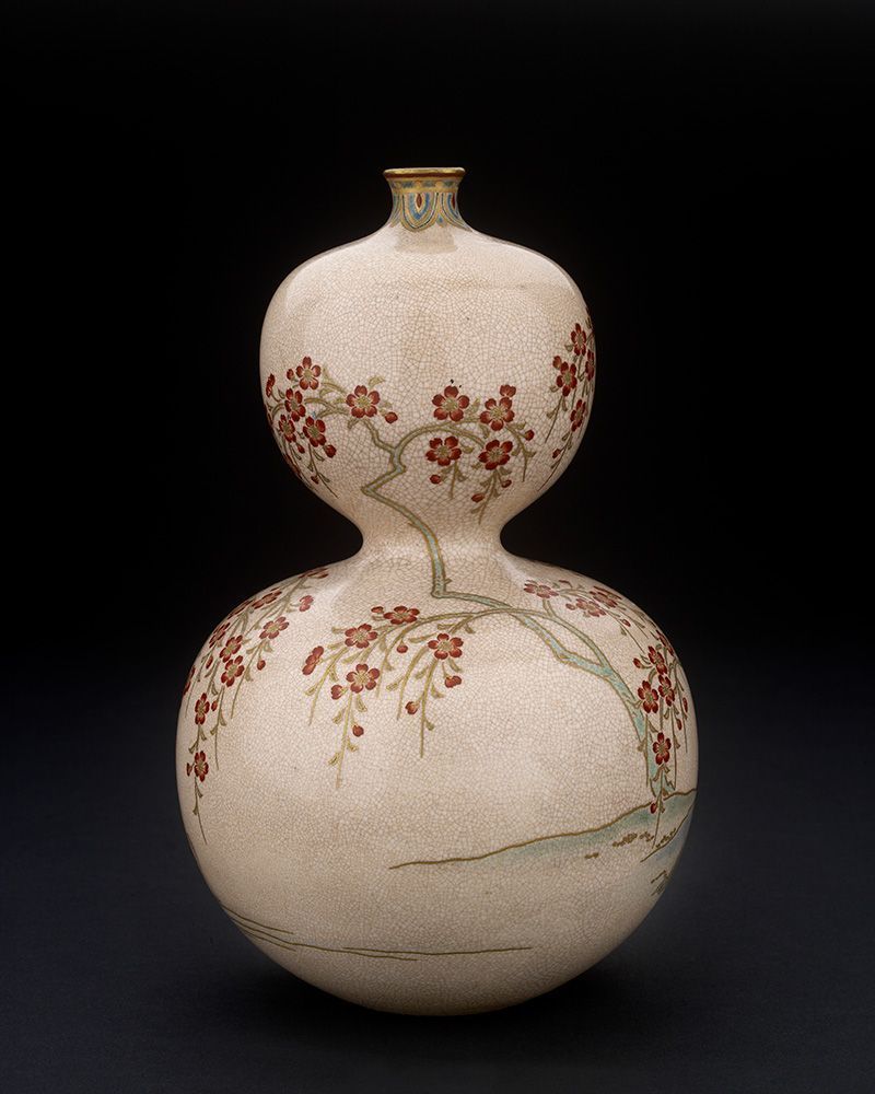 A photograph of the vase, a double-gourd form decorated with overglaze enamels. This photo shows sprawling cherry blossom