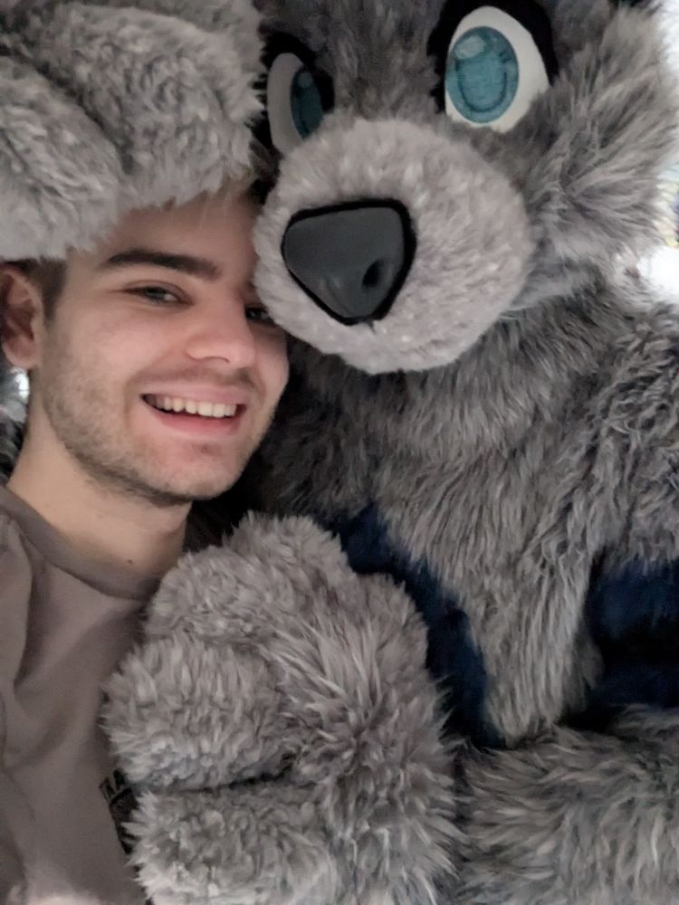 me and then someone wearing my fursuit hugging me