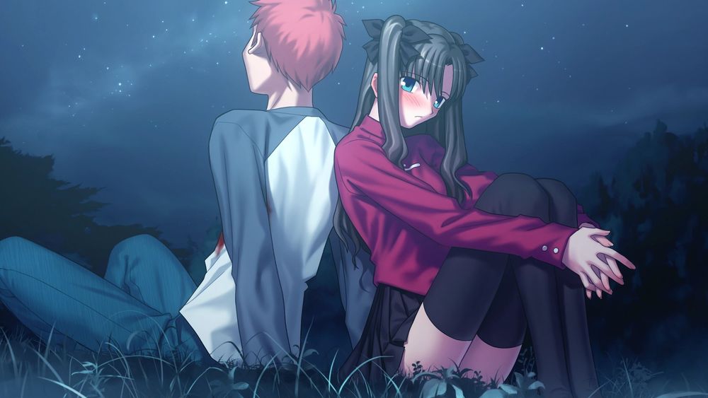 A picture of Shirou Emiya and Rin Tohsaka sitting on the ground, backs facing each other. Shirou is facing away from the camera, and has some blood on his shirt. Rin is facing toward the camera and blushing.