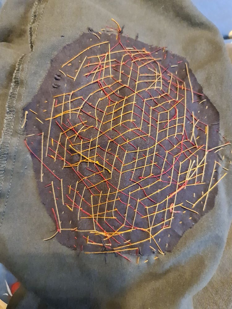 Sashiko reverse showing geometric thread patterns made by the stitches on the front