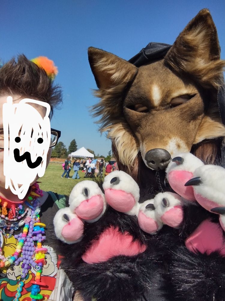 owlhops standing with a therian wearing a dog mask and big paws !