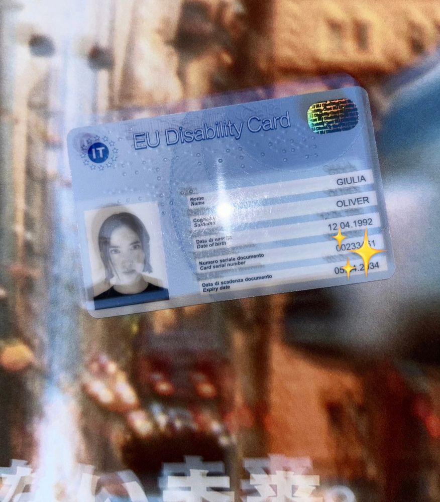 a blurred photo of a disability card with the photo of a woman and a old magazine background