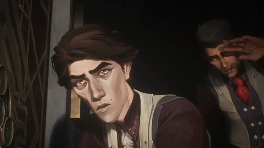 Viktor in Season 1 of Arcane when he and Jayce get caught by Mel trying to break into Heimerdinger’s lab. Viktor is crouched on the floor next to the lab door, and lit by Mel’s flashlight. His eyebrows are raised slightly, his mouth is in a surprised rounded shape, he’s looking up at Mel with confusion and surprise. Jayce can be seen in the background, bent over slightly and blocking the light from his face with his hand. He looks equally surprised.