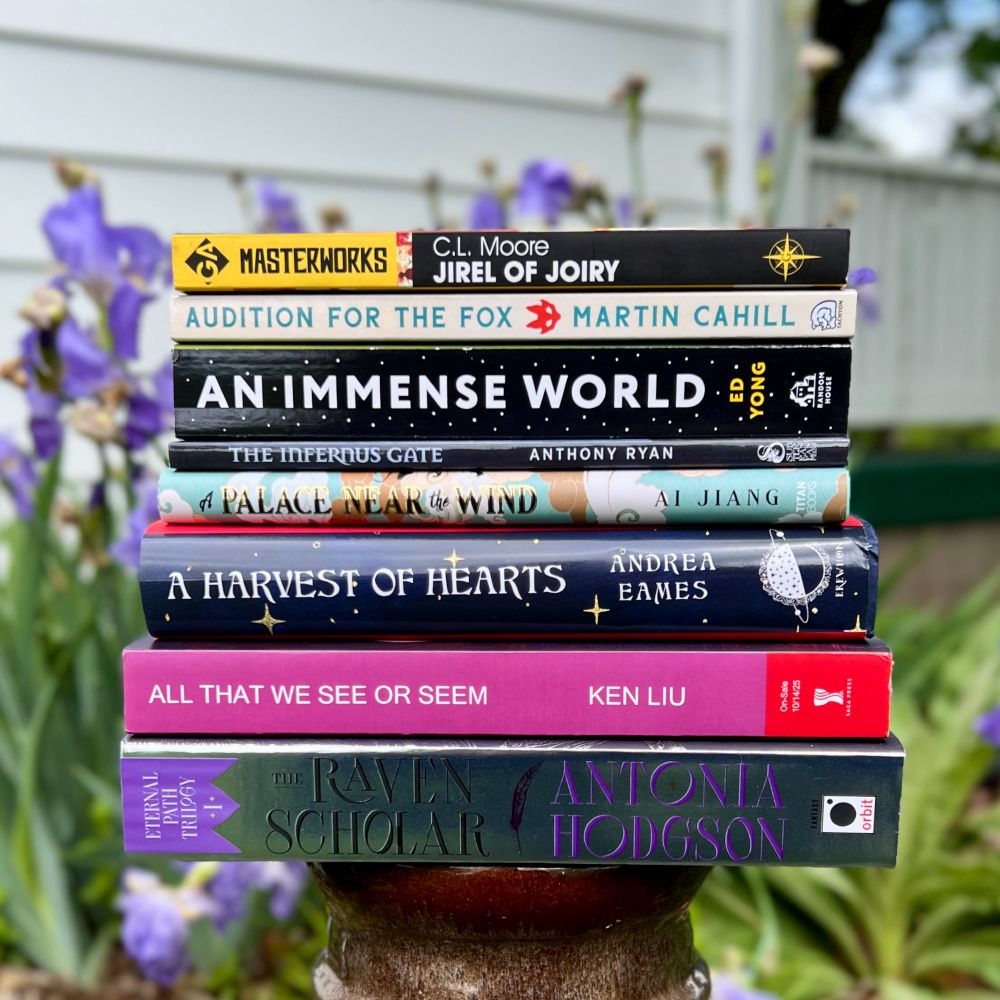A stack of books before blooming irises (bottom to top): THE RAVEN SCHOLAR by Antonia Hodgson, ALL THAT WE SEE OR SEEM by Ken Liu, A HARVEST OF HEARTS by Andrea Eames, A PALACE NEAR THE WIND by Ai Jiang, THE INFERNUS GATE by Anthony Ryan, AN IMMENSE WORLD by Ed Yong, AUDITION FOR THE FOX by Martin Cahill, JIREL OF JOIRY by C.L. Moore

#booksky 📚📘💙