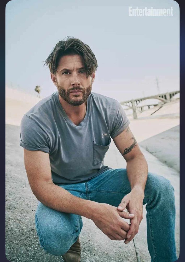 Jensen Ackles wearing jeans and a gray tshirt looking obnoxiously sexy with his signature effortless smolder. Male modeling son of a bitch. 