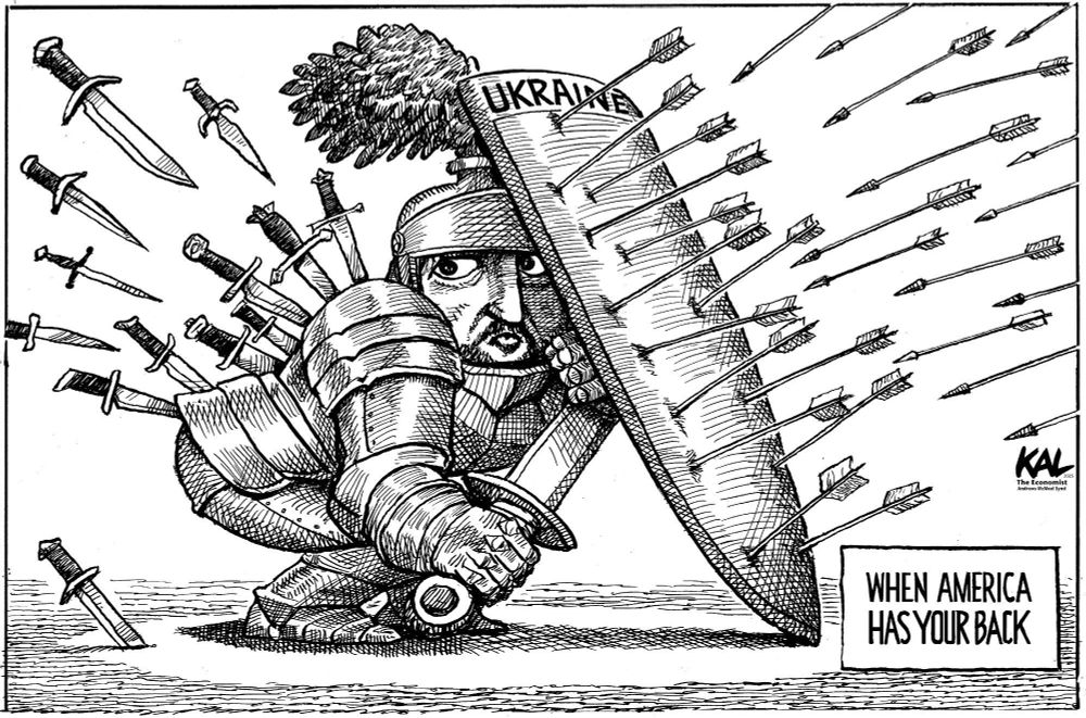 Zelensky, in medieval armor, ducks behind a shield titled "Ukraine" to avoid being hit by dozens of arrows. Meanwhile, dozens of daggers are stabbing him in the back.