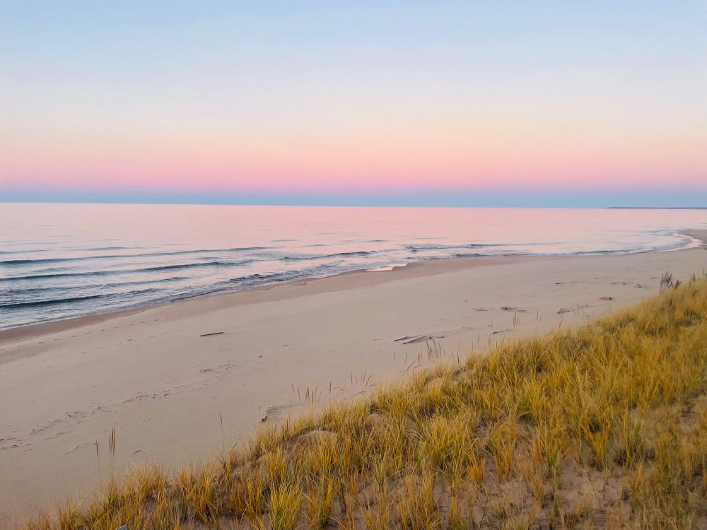 Pastel pink tones in the sky over Lake Superior at sunset