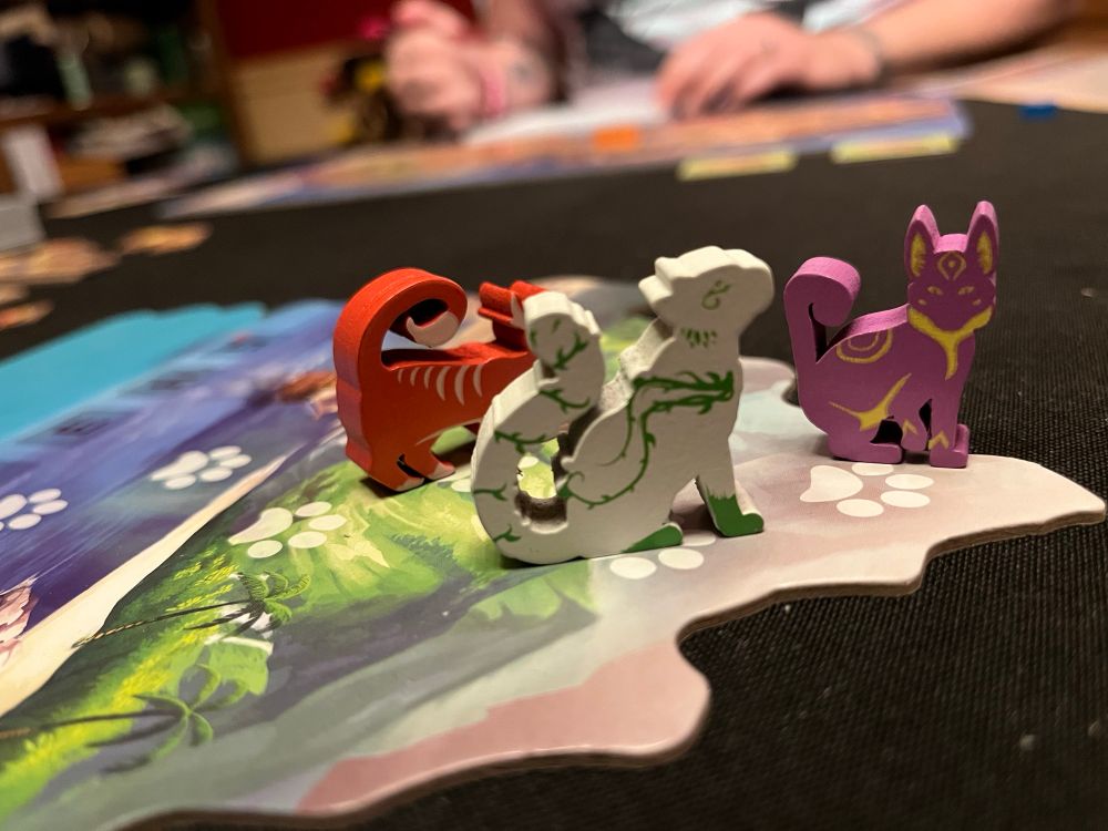 Isle of Cats board game - showing the round board with player tokens in order of play. 