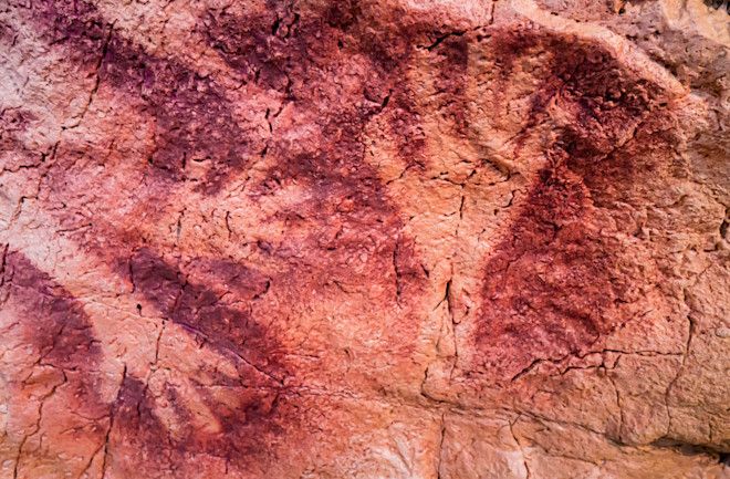 Red hands silhouette of the cave of the Salin Fountain, Cantabria, Spain, similar to the cave images at Grottes de Gargas in France. (Image Credit: JESUS DE FUENSANTA/Shutterstock)
