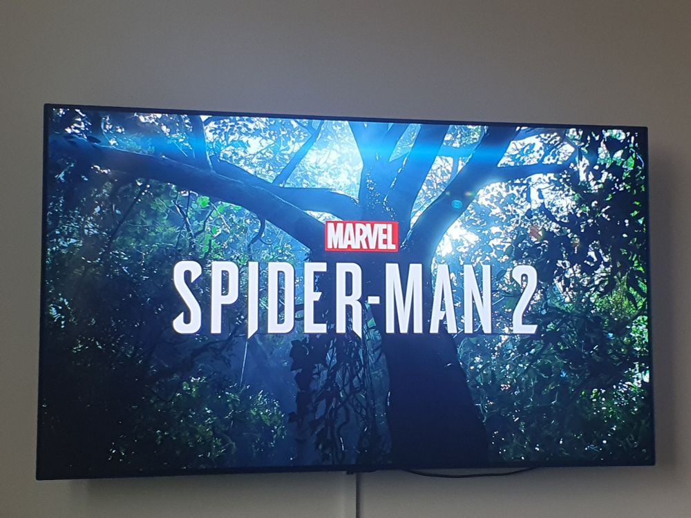 Logo of "Spider-Man 2" in front of forest background