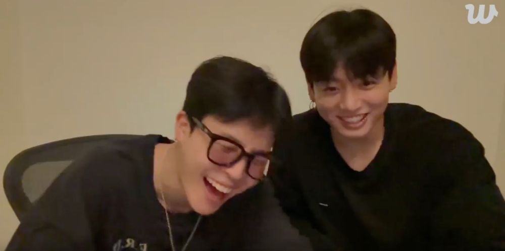 Jimin and Jungkook live screenshot both in black and laughing hard. 