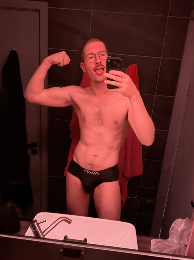 The same man flexes and pulls his tongue 