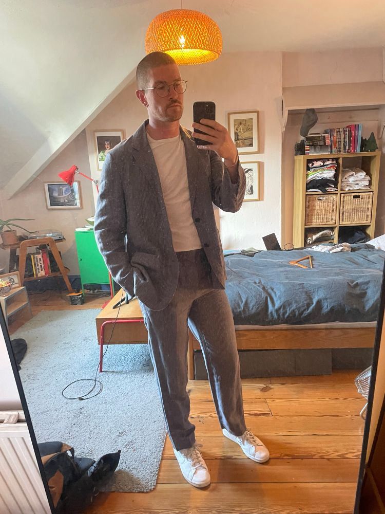 The same man with the suit unbuttoned