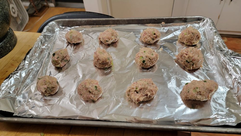 Turkey meatballs on a sheet pan, about to be baked 