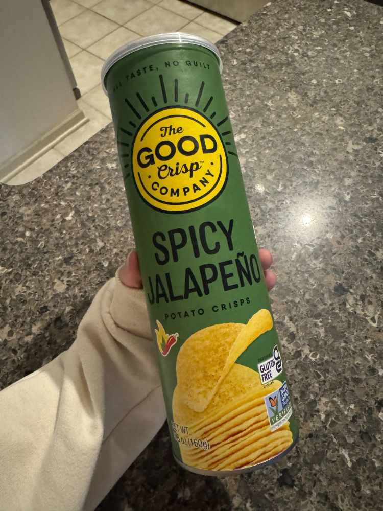 a green canister of "spicy japaeño" chips. the canister has a picture of the chips and a red pepper to indicate that the chips are spicy. 