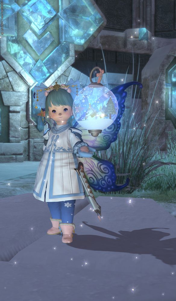 a green haired lalafell in a white and blue outfit with pink highlights, with blue fairy wings and a snow globe standing at a snowy temple