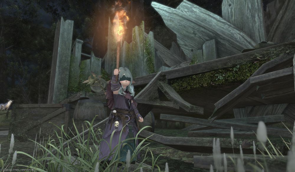 green-haired lalafell with hooves wearing tattered purple and green robes carrying a torch in front of the ruins of a cottage