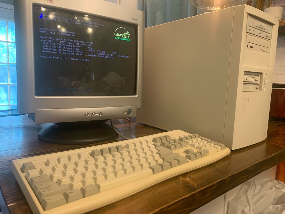 1990s beige PC tower with a beige keyboard and a silver tube style monitor
